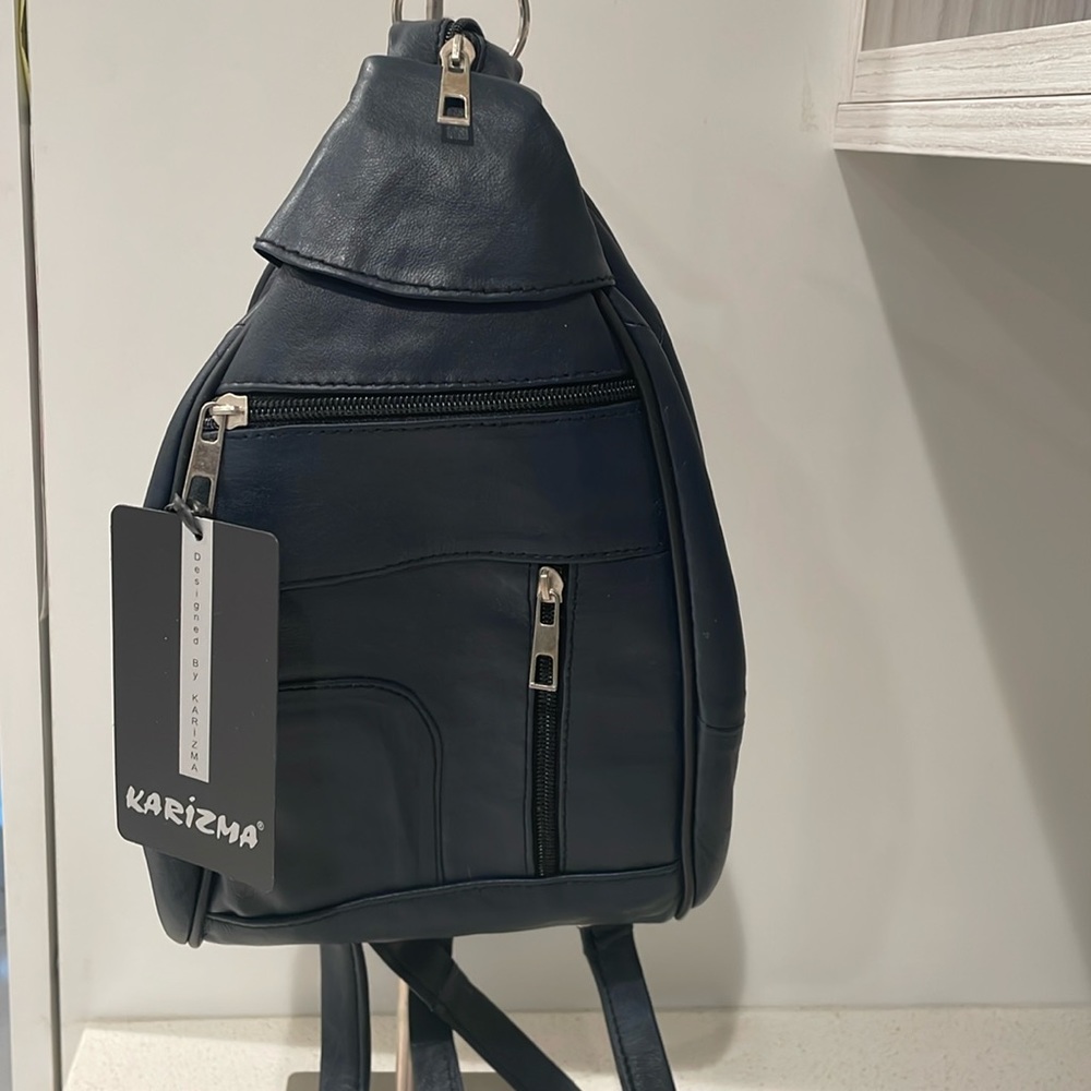 New. Never used, use as a crossbody bag also converts into a small backpack.